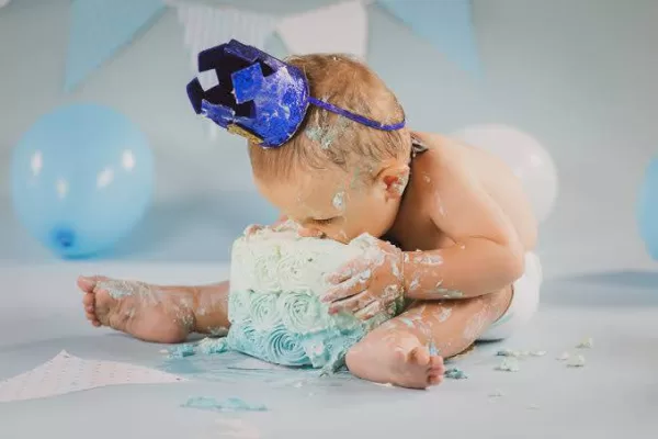 boy with face in smash cake